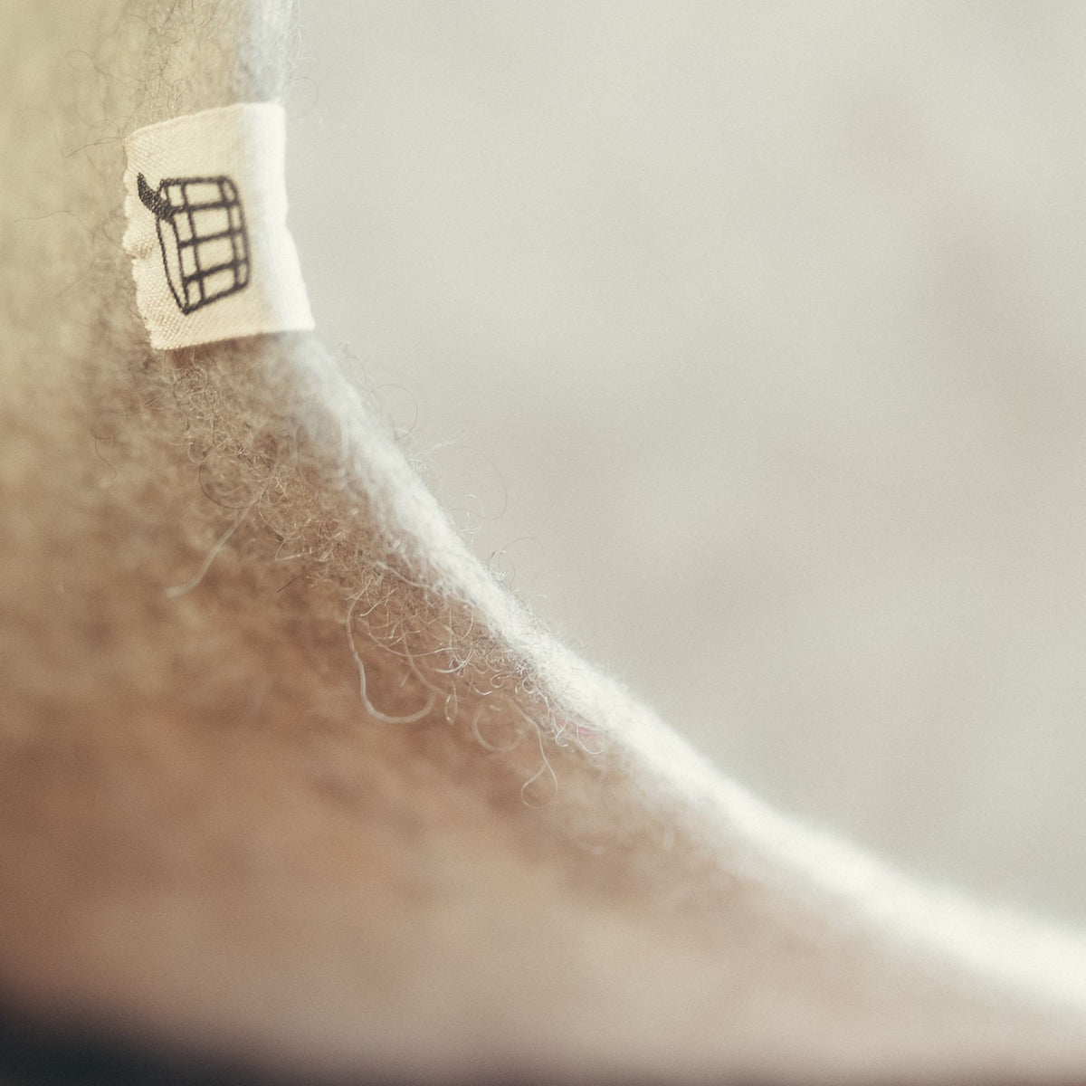 Close-up of the dense hand-felted wool edge of the Nordic Birch sauna hat, roughly 6mm thick