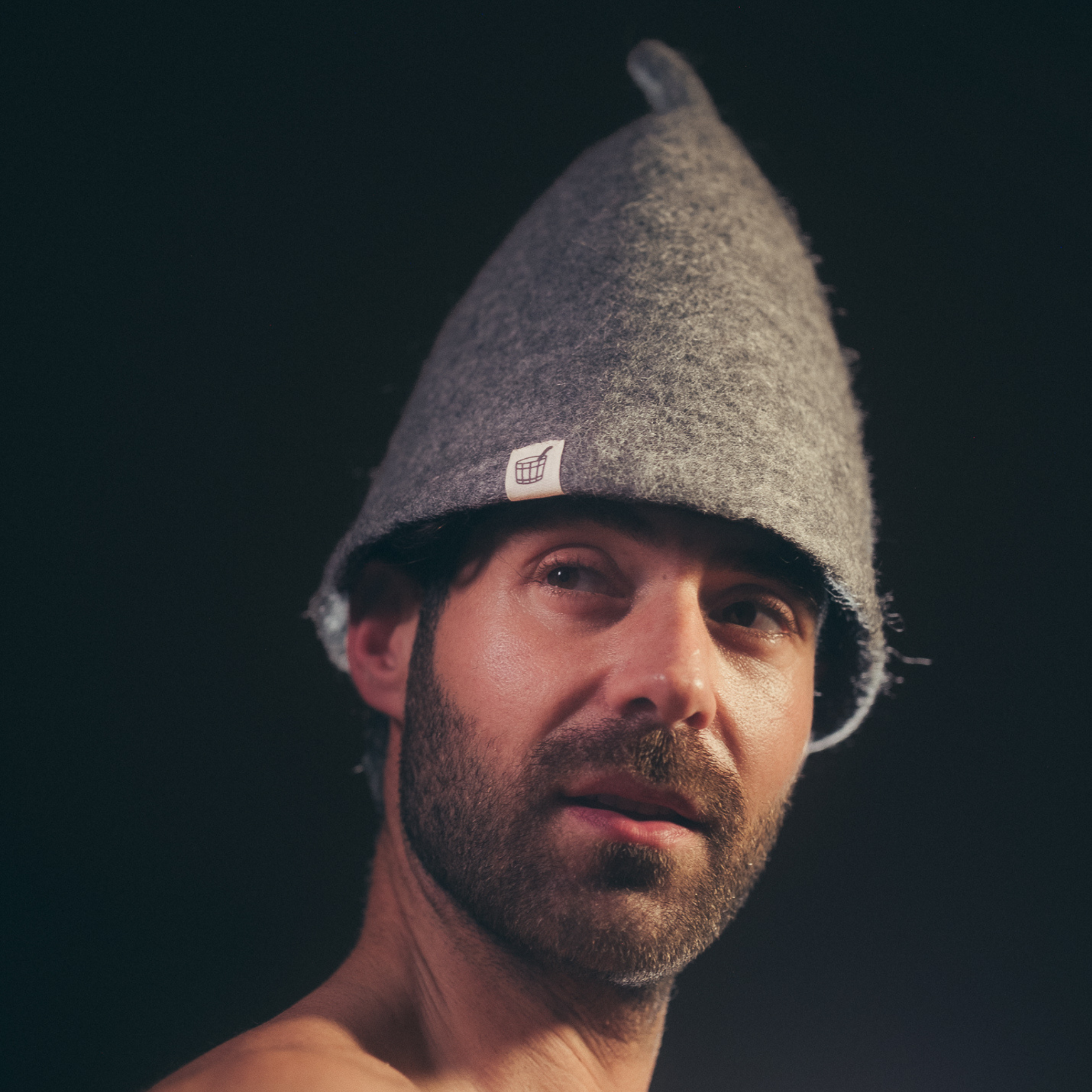 Man wearing premium wool felt sauna hat inside 
