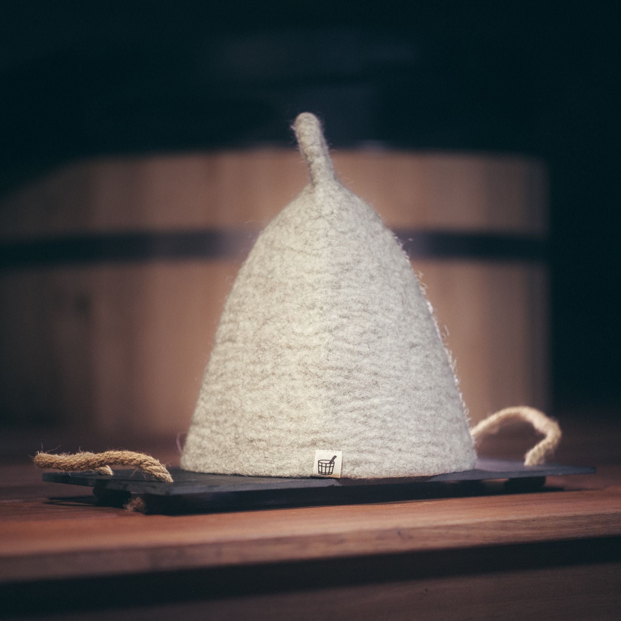 Cult of Sauna wool sauna hat in Nordic Birch colour on dark background
