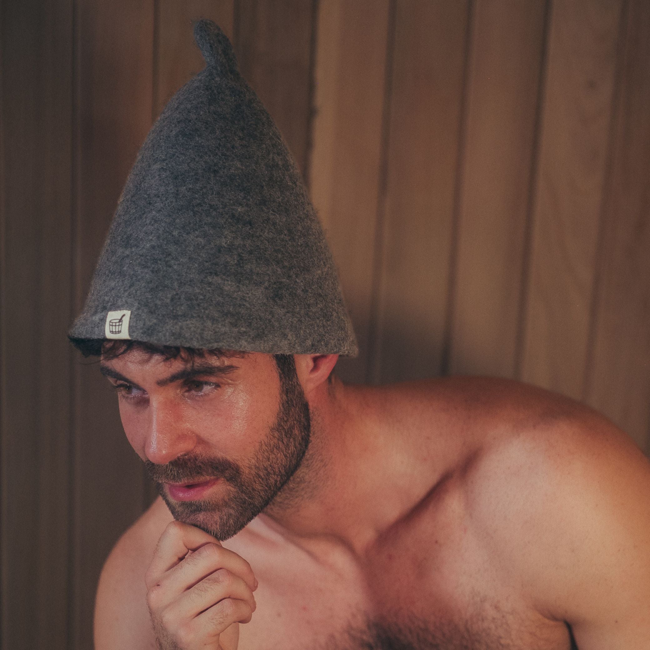 Man wearing premium wool felt sauna hat inside 