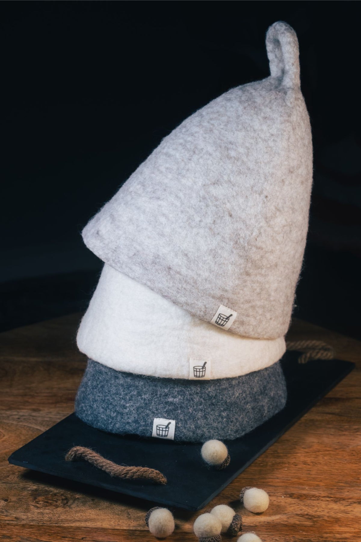 Three Cult of Sauna wool sauna hats stacked: Nordic Birch, Fjord Ice and Volcanic Grey